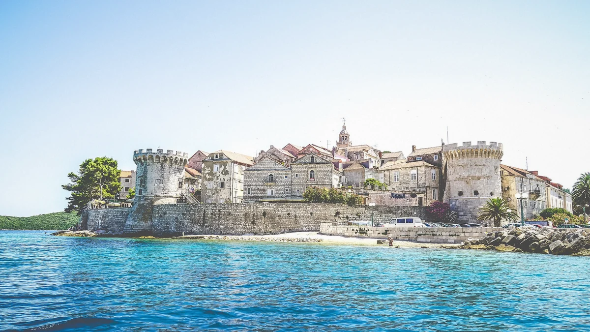 Walled old town of Korcula with towers and turquoise water in Croatia, the smaller island compared against Hvar