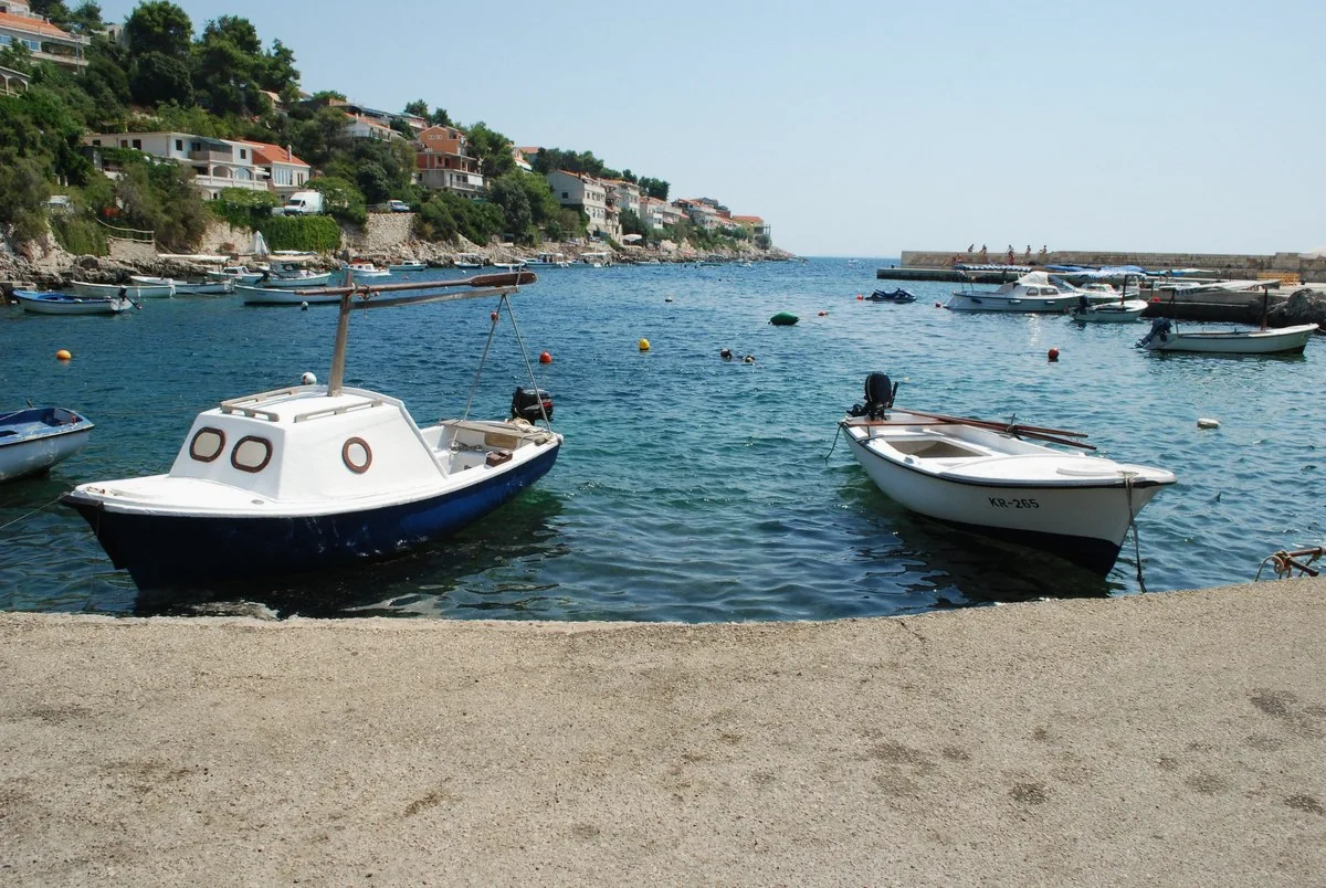 Clear turquoise bay with small moored boats at Zavalatica on the Korcula coast in Croatia