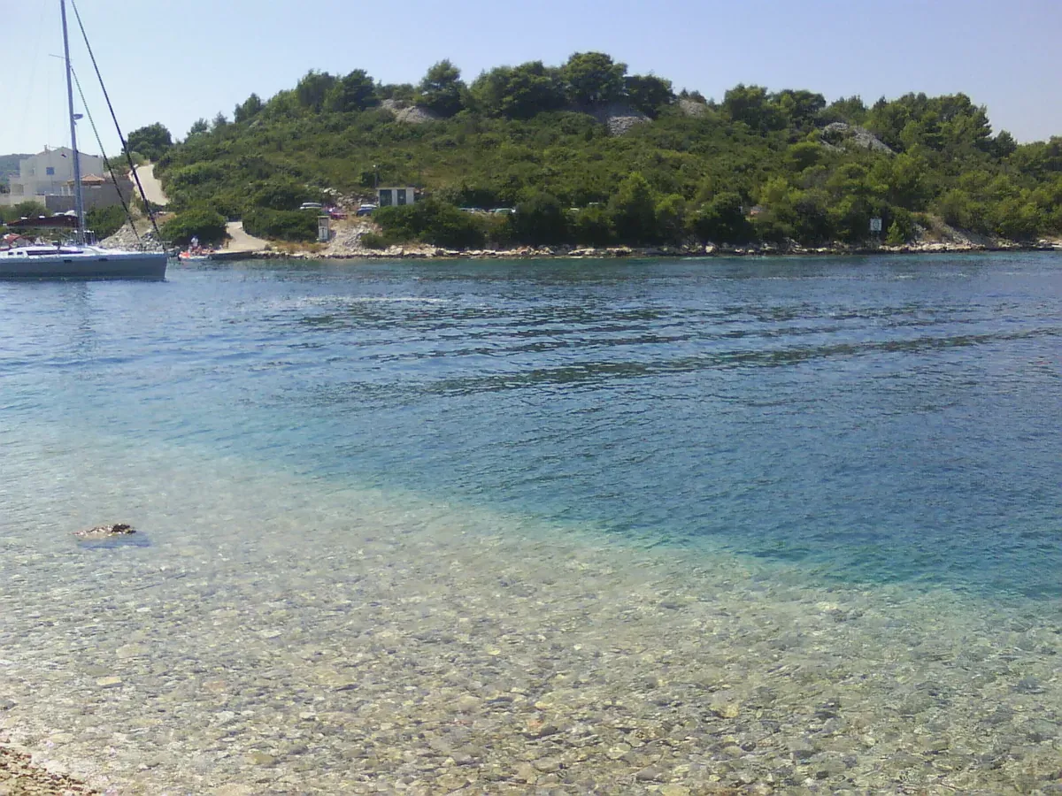 Pebble beach and clear water at Vrnik island near Korcula in Croatia, a Sail Away swim stop